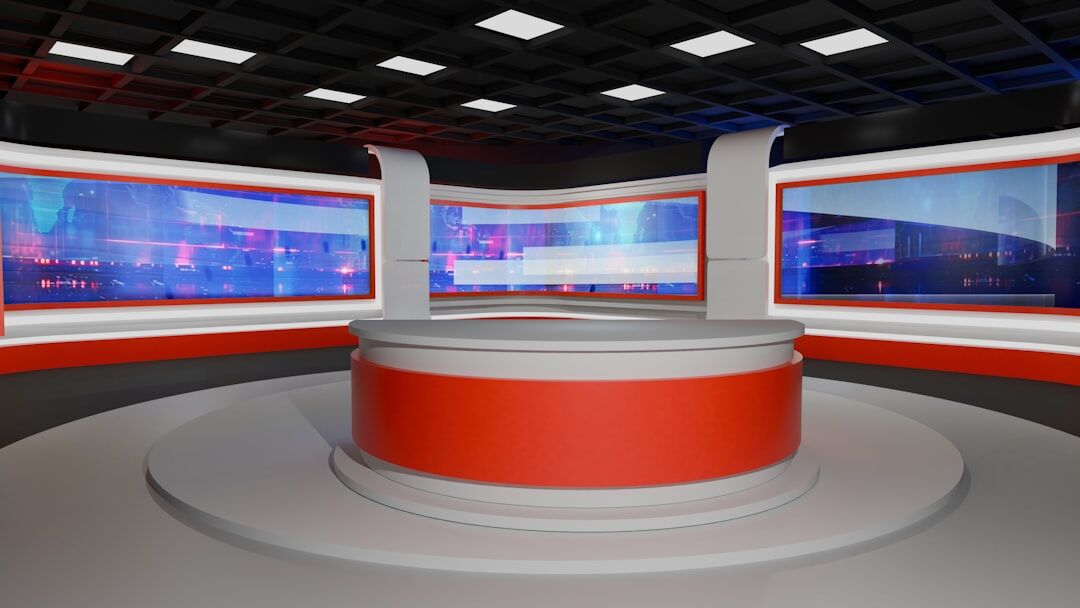 Professional TV newsroom anchor desk with studio monitors and lights