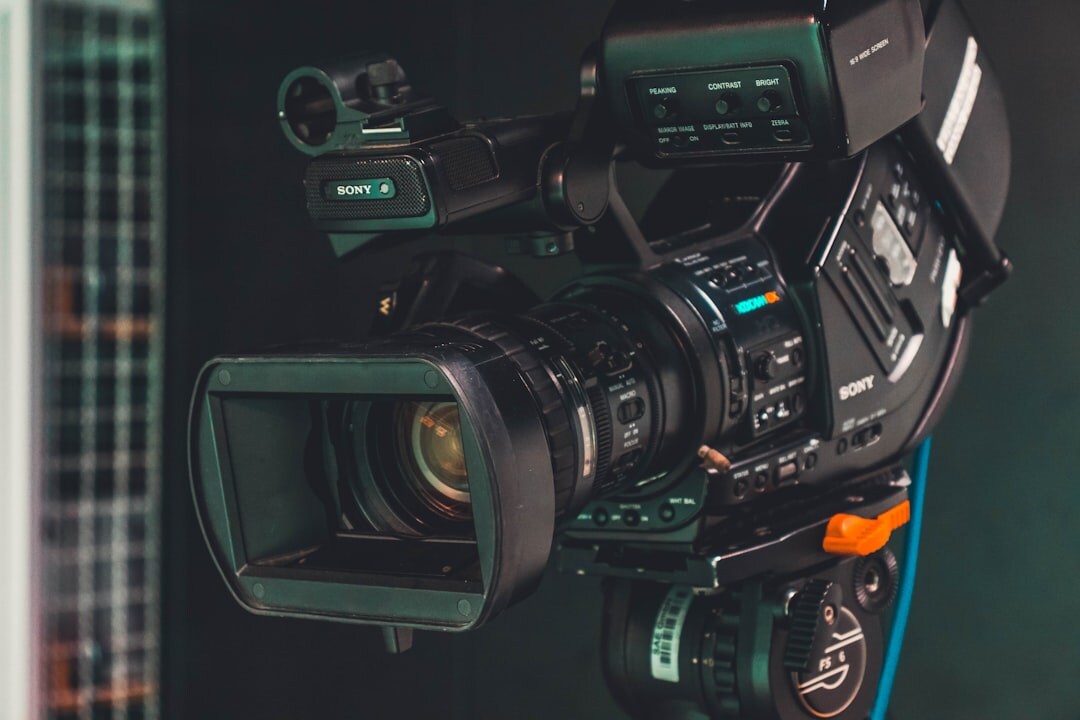 Professional broadcast video camera on tripod in studio setting